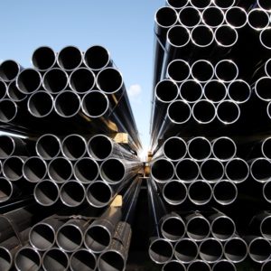 stack of steel tubes against blue sky